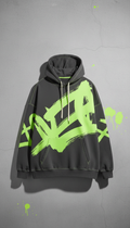Oversized acid-lime graphic hoodie, Single product-focused shots at a slight 3/4 angle on textured concrete surfaces or...